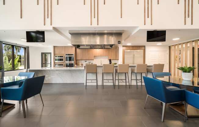 an open kitchen and dining area with a table and chairs Bedroom at Magnolia Square, Naples