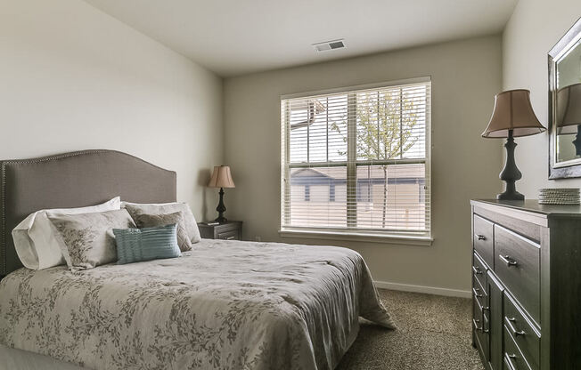 a bedroom with a large bed and a dresser