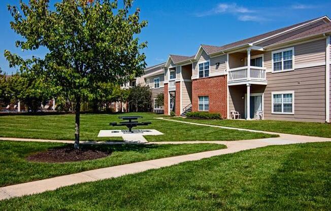 Picnic table by tree in proximity to apartment buildings