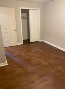 a living room with a wooden floor and a white door