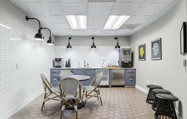 a dining room with a table and chairs and a kitchen