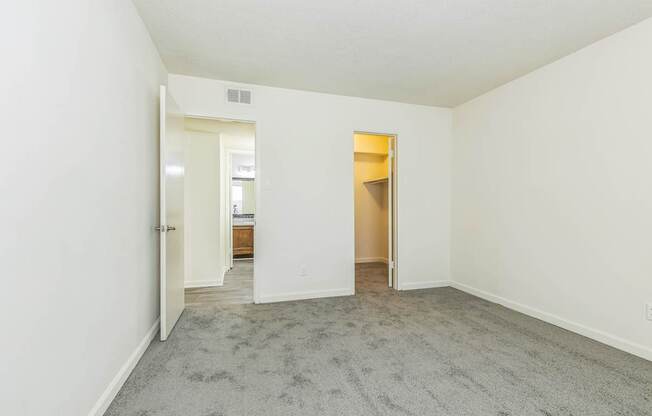 A room with a carpeted floor and white walls.