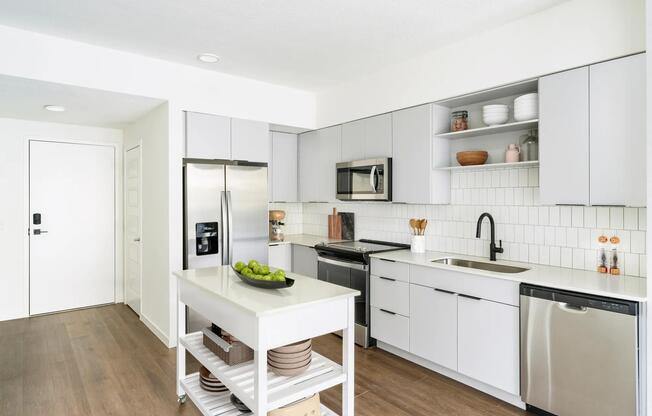 A light-cabinet kitchen with a movable island offers flexible, effortless living throughout your Modera Encore Tampa home.