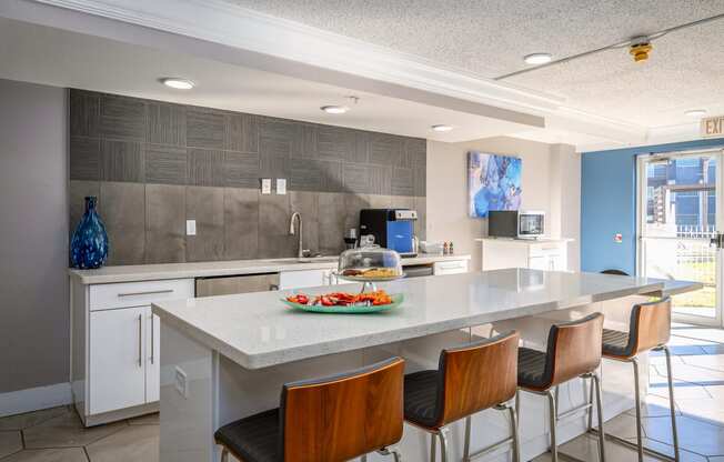 a kitchen with a large island and bar stools