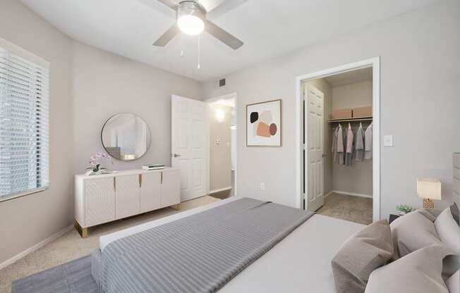 a bedroom with a large bed and a ceiling fan