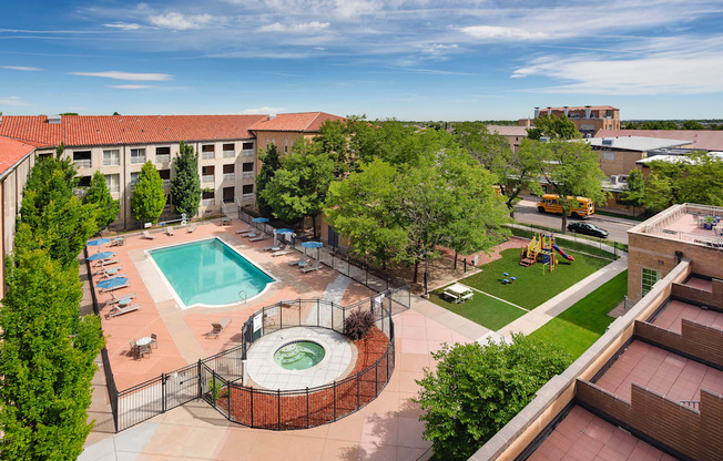 A view of a pool and playground area from a high angle.
