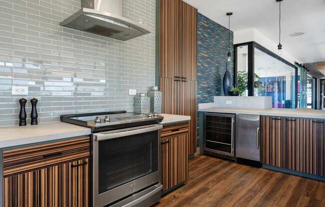 A modern kitchen with a stainless steel oven and wooden cabinets.
