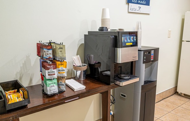 a coffee table with a coffee maker and a refrigerator