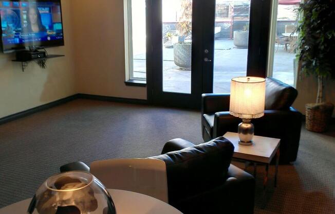 Community Room with TV at Metropolitan Collection Apartments, Renton, WA, 98057