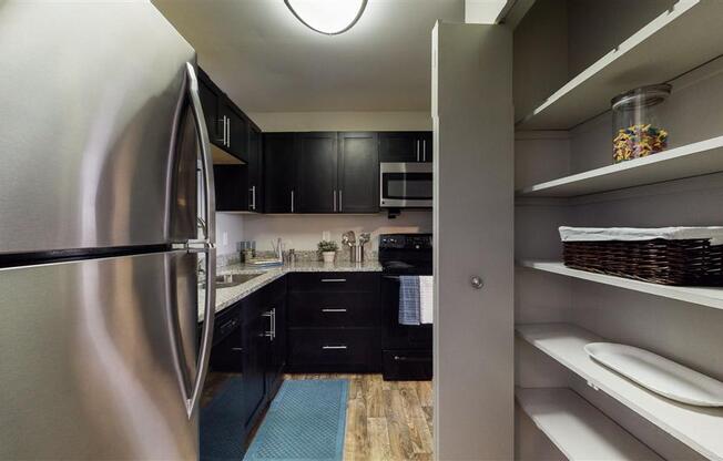 a kitchen with a stainless steel refrigerator freezer next to a sink
