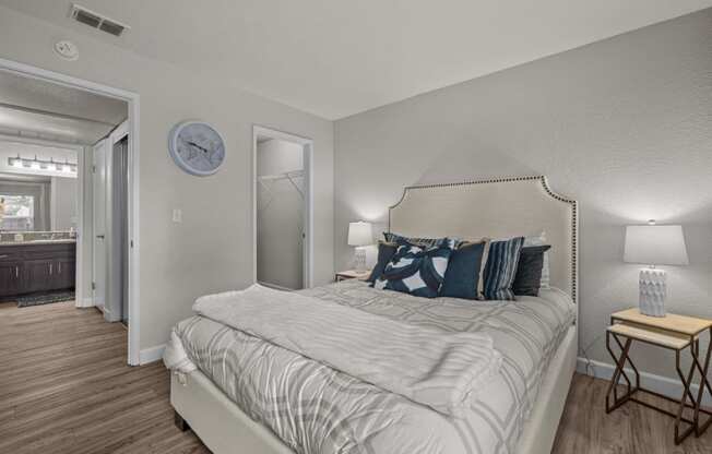 a bedroom with a large bed and a mirror