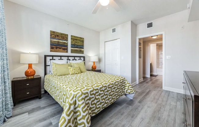 a bedroom with a bed and a ceiling fan