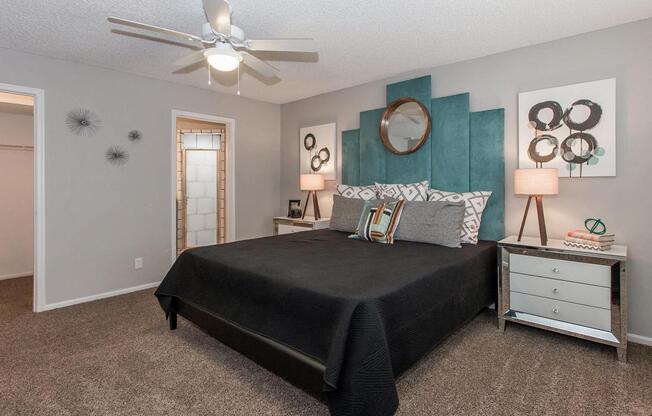 a bedroom with a bed and a ceiling fan