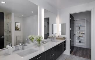 a bathroom with two sinks and a large mirror