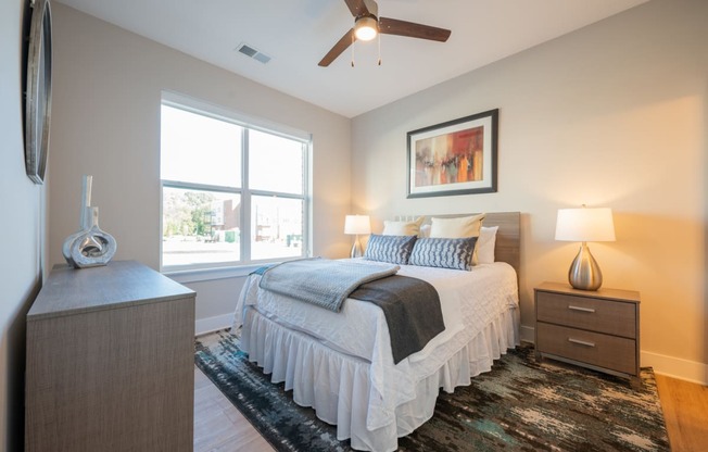 a bedroom with a bed and a ceiling fan