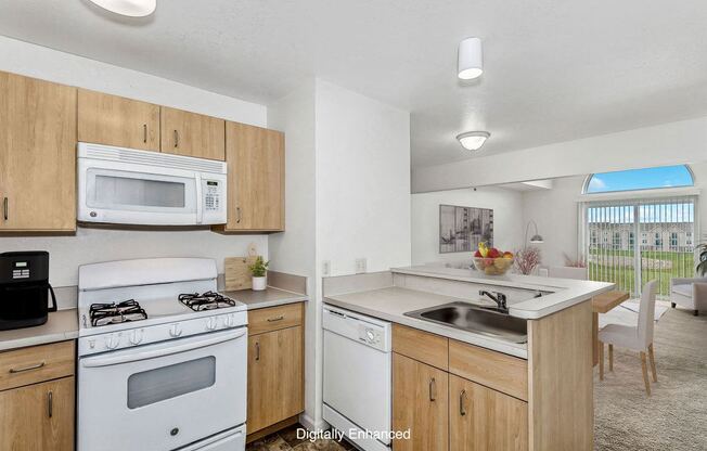 a two bedroom kitchen with a stove microwave and sink at Fieldstream Apartment Homes, Iowa