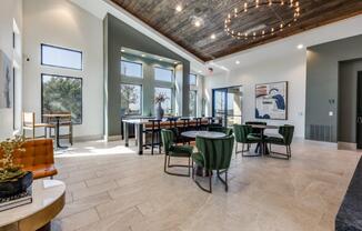 A modern dining room with a wooden ceiling and a large table surrounded by chairs.