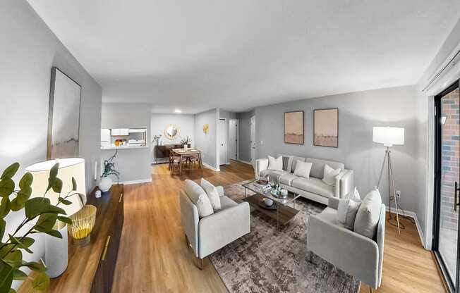 a living room with couches and chairs and a rug