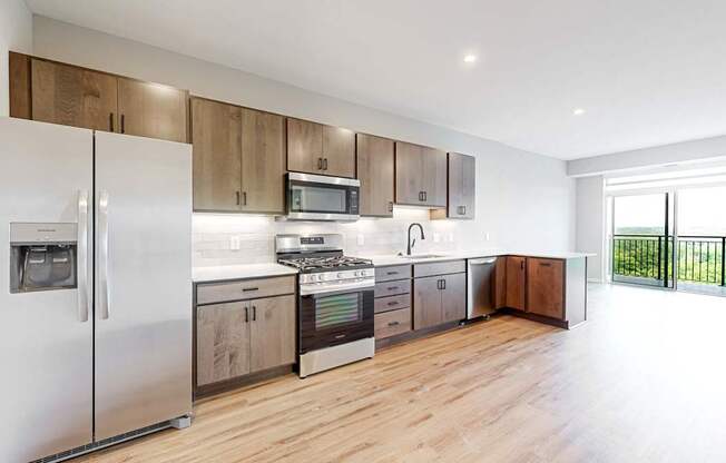 a kitchen with stainless steel appliances and wooden cabinets