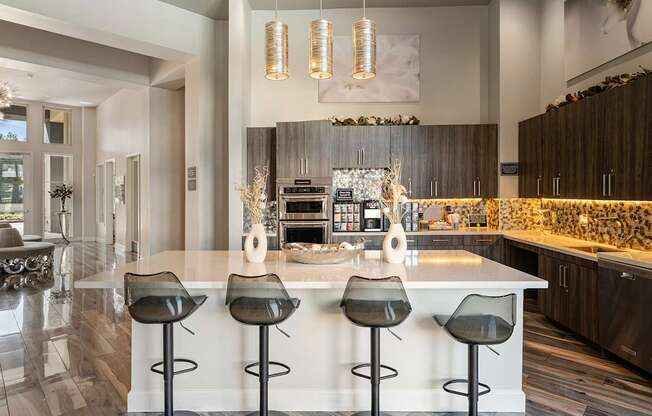 A modern kitchen with a bar area and a dining table.