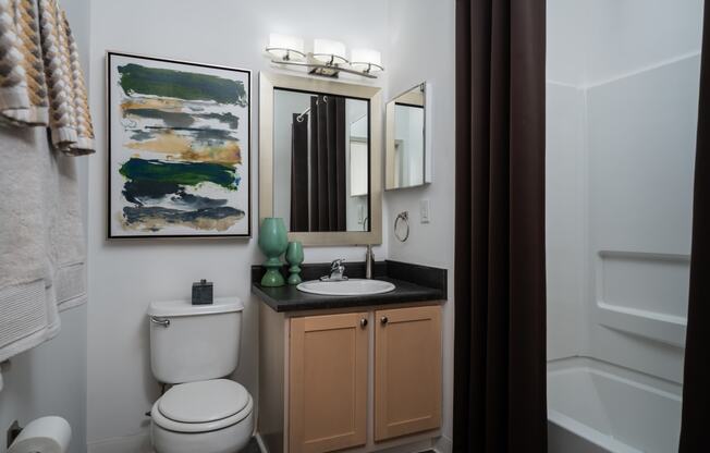 a small bathroom with a toilet sink and bathtub