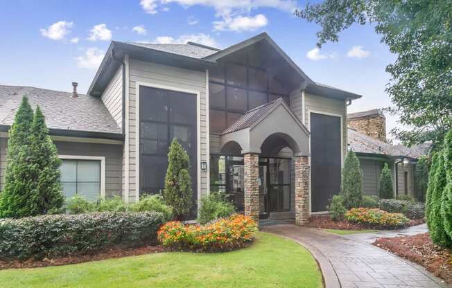 A house with a grey roof and a stone archway entrance at Ridge Crossings Apartments, Hoover, AL 35244
