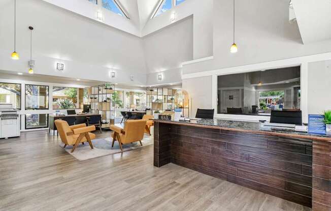 the lobby of a hotel with a reception desk and chairs at Summerwood Apartments, Santa Clara, CA