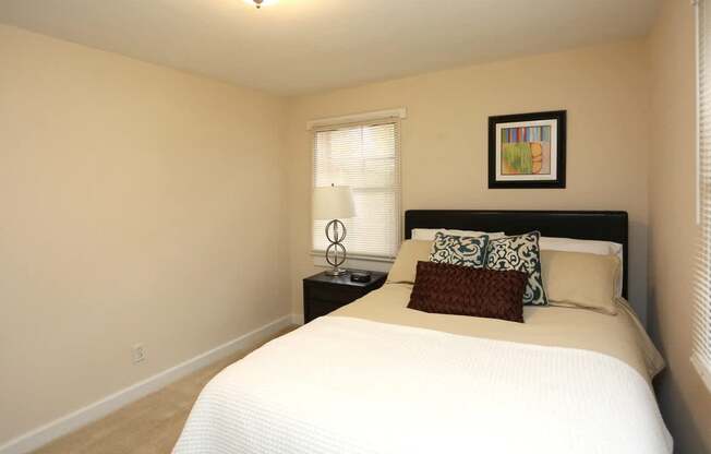 View of bedroom model with bed and nightstand
