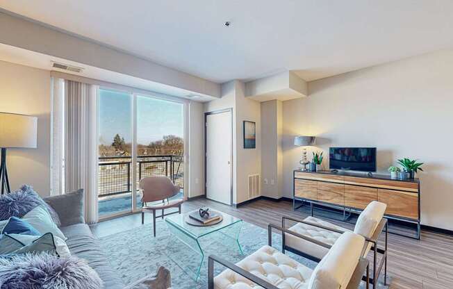 A modern living room with a glass coffee table and a flat screen TV.
