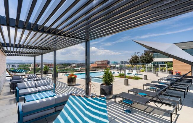 Poolside lounge with panoramic mountain views, shaded hammocks, and space to unwind above the city.