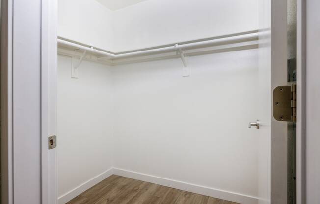an empty room with white walls and a door