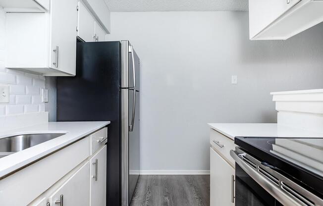 a kitchen with a stove sink and refrigerator