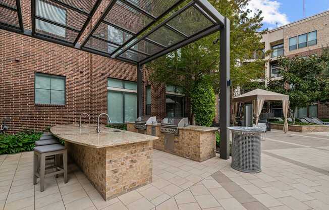 a patio with a hot tub and a grill