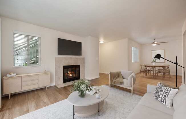 a living room with a fireplace and a white rug at Rush River Apartments, Sacramento, 95831