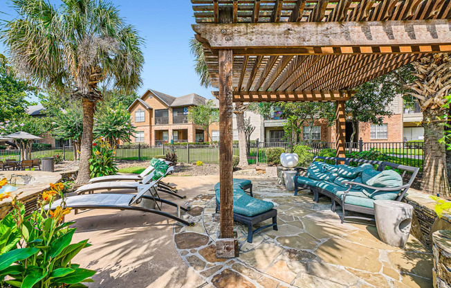 a patio with lounge chairs and a pergola at River Pointe, Conroe, TX, 77304