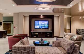 Spacious and luxurious lobby with a television and ample seating at Quarry at River North