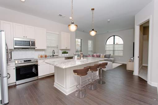 a kitchen and living room with white cabinets and a white counter top at Fairfax, Grandview, OH