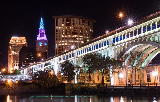 A bridge over a body of water with lights on it.