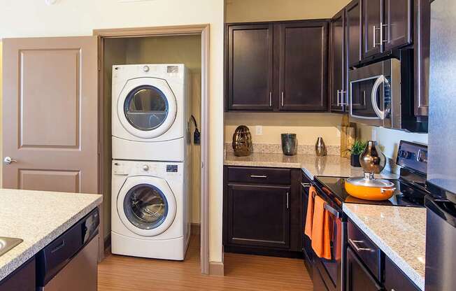 a kitchen with a washer and dryer in it