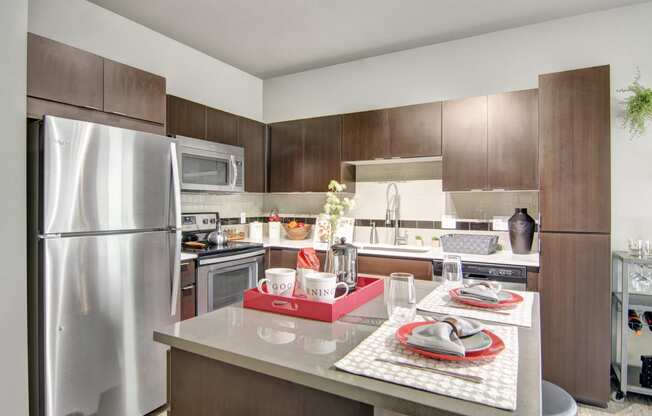 a kitchen with wood cabinets and stainless steel appliances