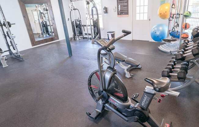 A gym with a stationary bike in the foreground.