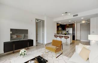 a living room with a couch and a kitchen in the background