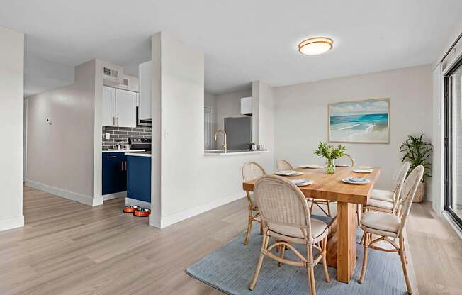 A dining room with a table set for four.