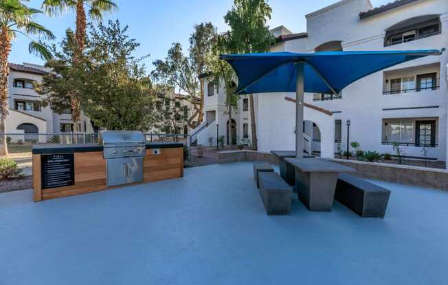 a backyard with a grill and picnic table