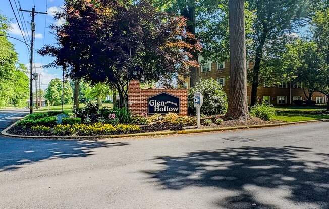 an empty street with a sign in front of a building at Glen Hollow, Croydon, PA