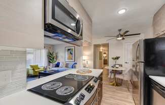 Kitchen with Electric Stove and Microwave  at Canyon Terrace Apartments, Folsom, CA, 95630