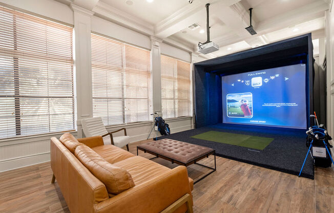 a living room with a projector screen and a couch