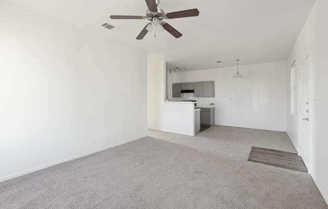 Affordable Apartments for Rent in Austin, TX 78724 – Huntington Meadows – A living room with a ceiling fan and carpeted floor.