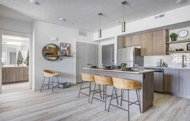 Kitchen with counter-height island, wood tone flooring, and designed furnishings