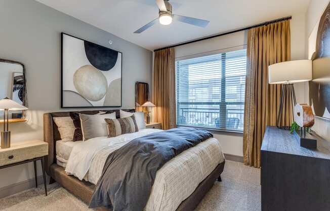 a bedroom with a large bed and a ceiling fan